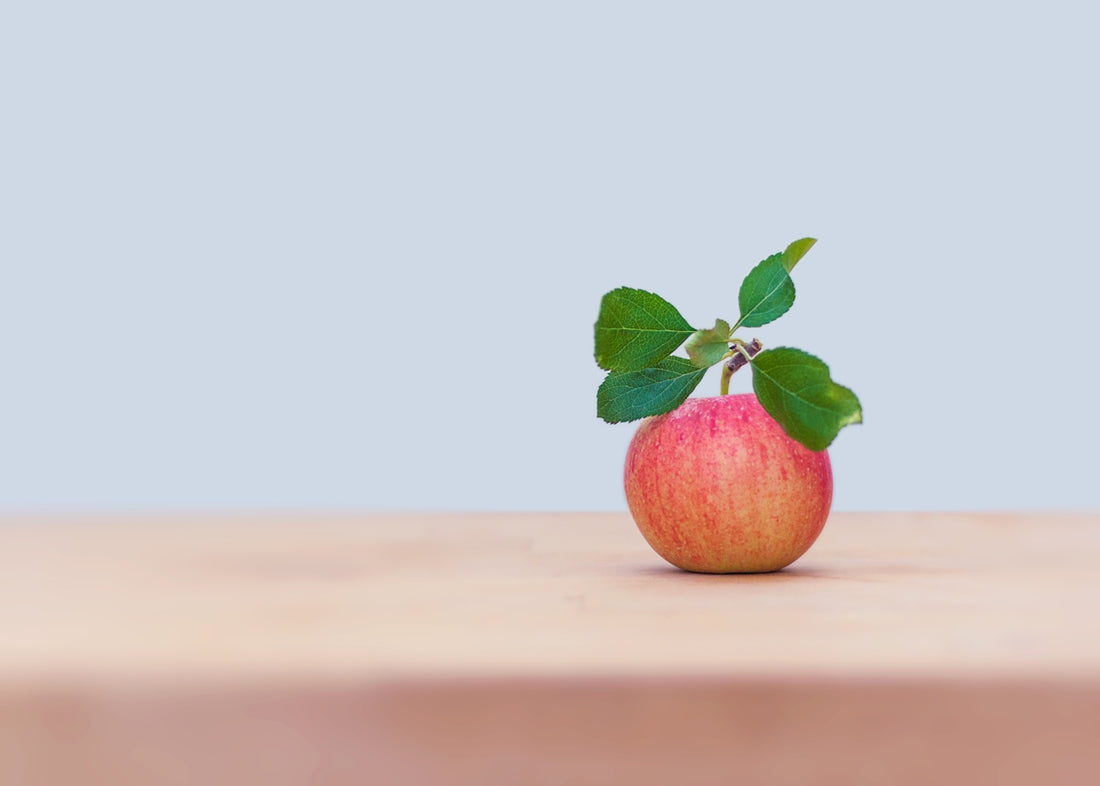 red apple on brown wooden table