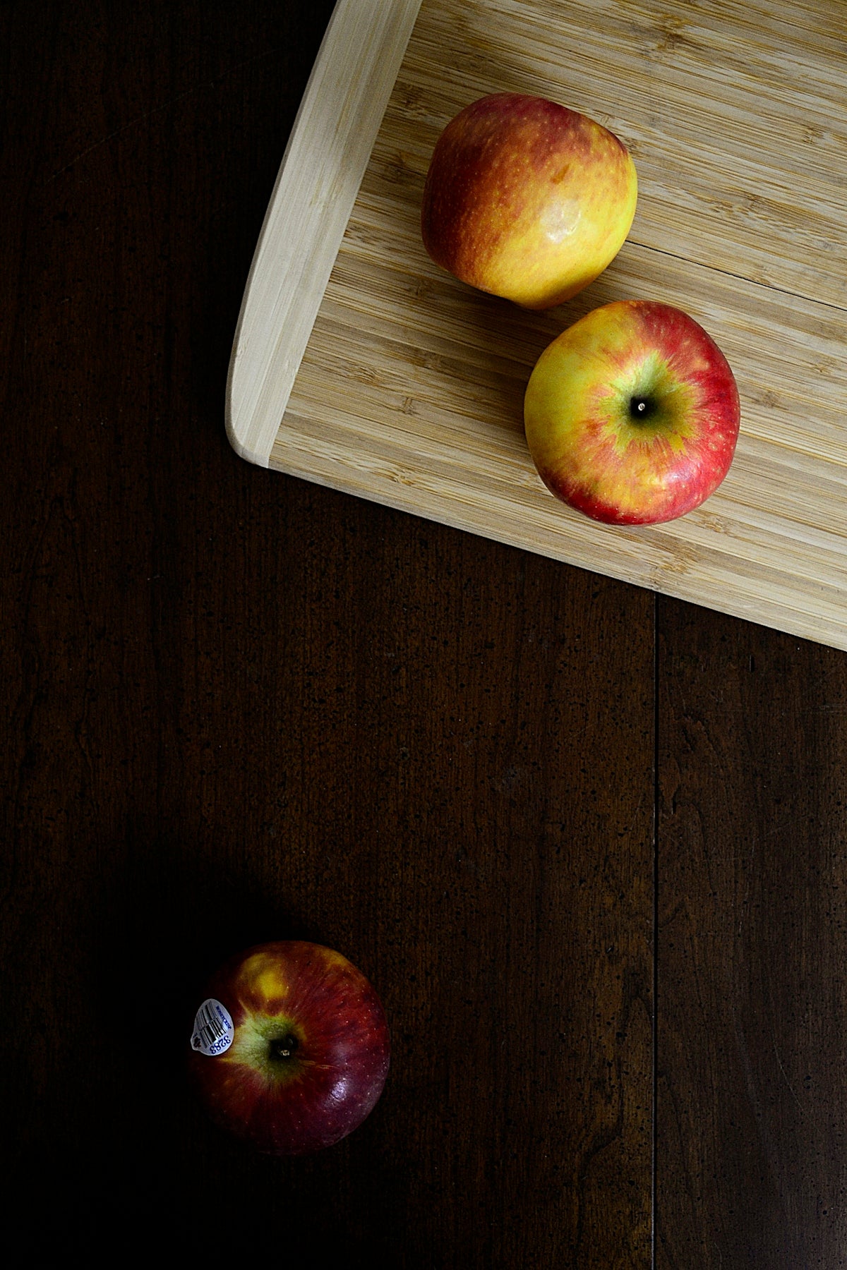 red and yellow apple fruit on brown wooden table