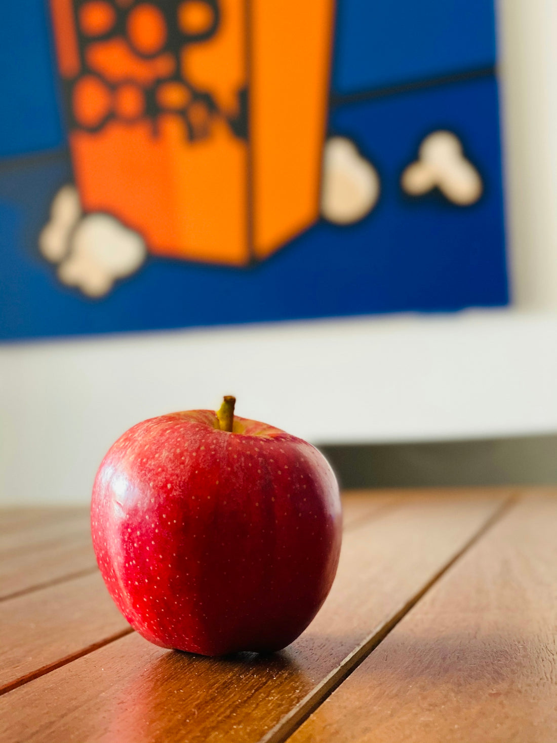 red apple fruit on brown wooden table