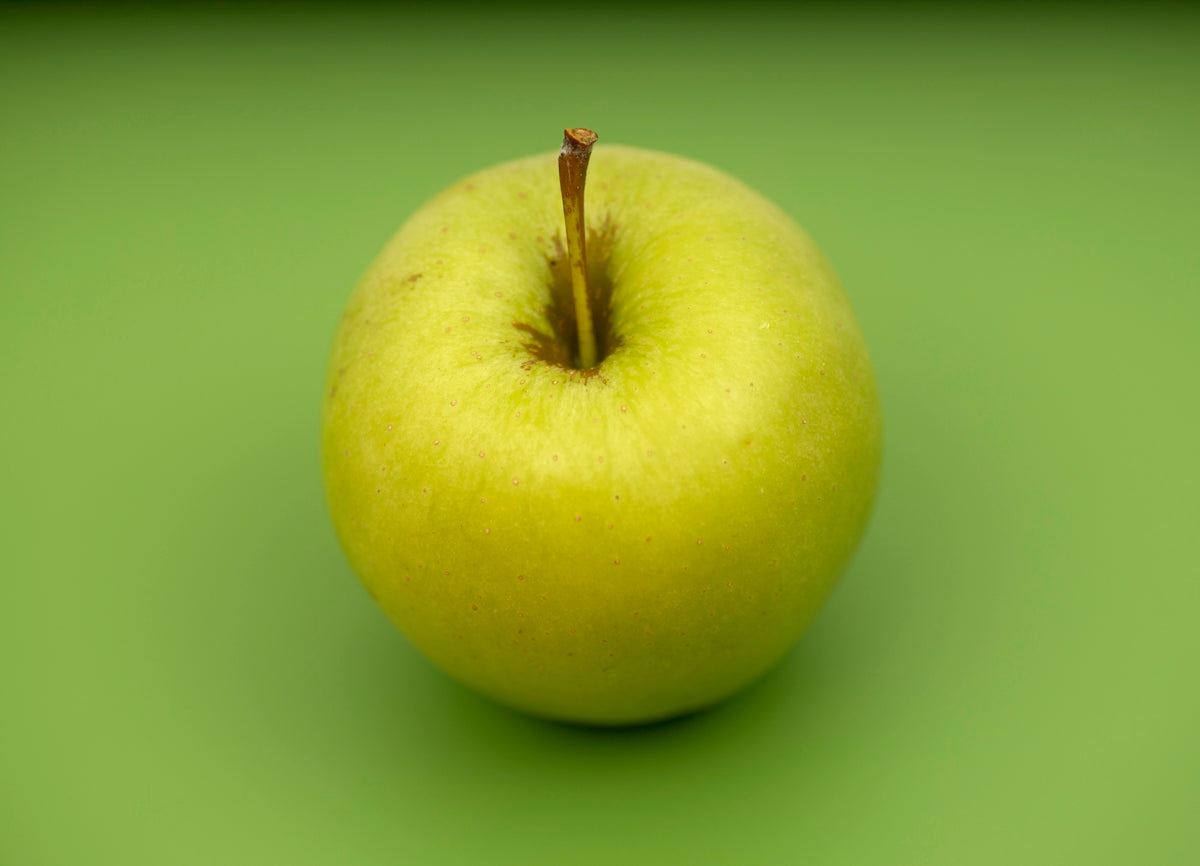 green apple fruit on green surface