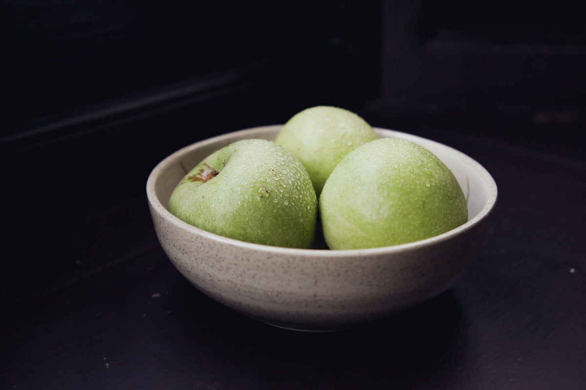 green apple fruit on white ceramic bowl