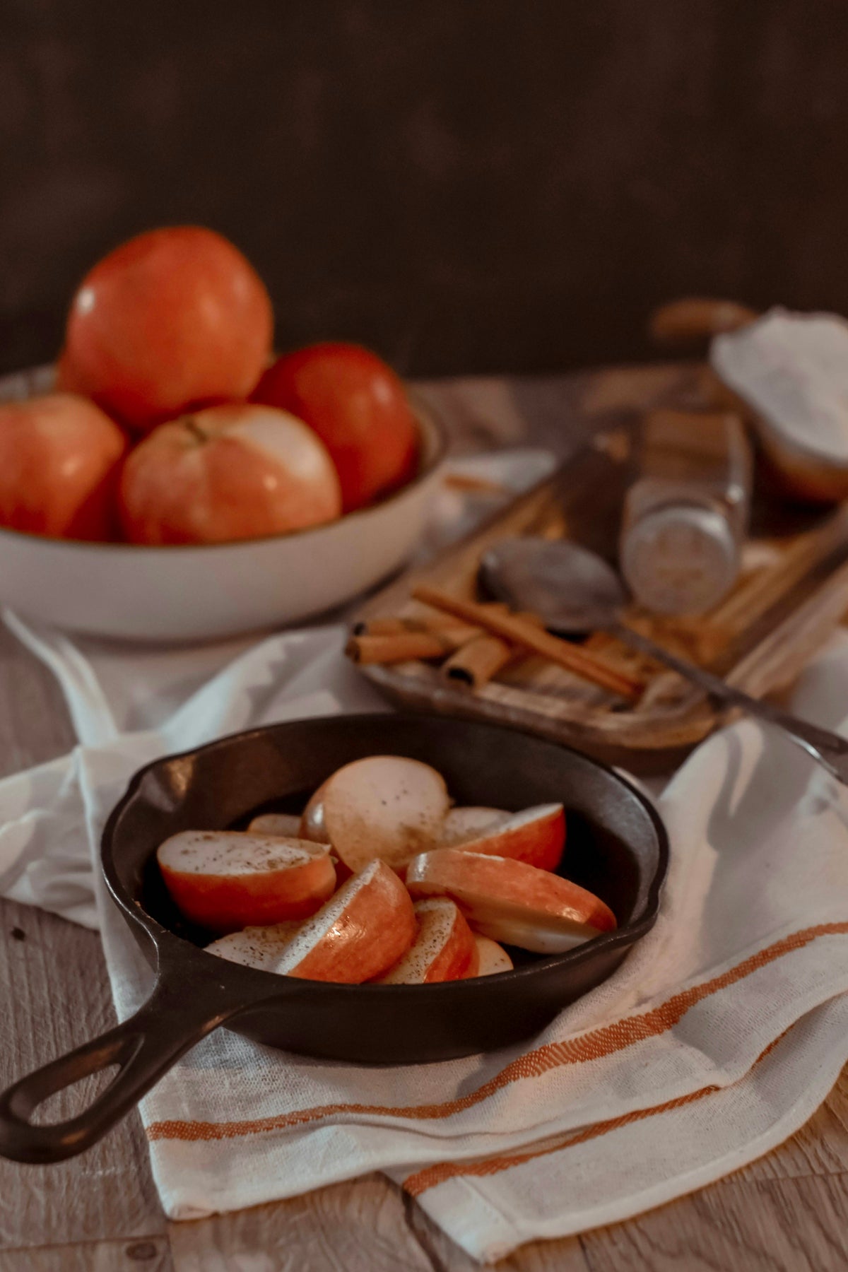 a pan filled with sliced apples on top of a table