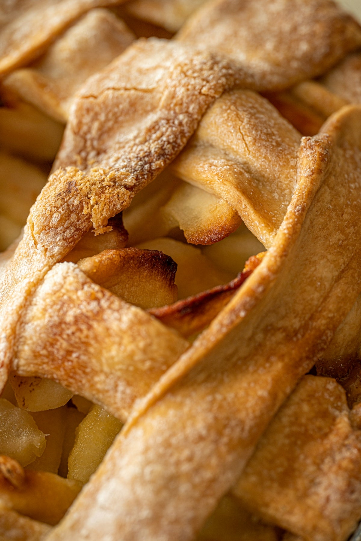 a close up of a pie with apples in it