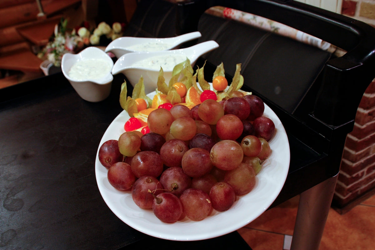a white plate topped with grapes and apples