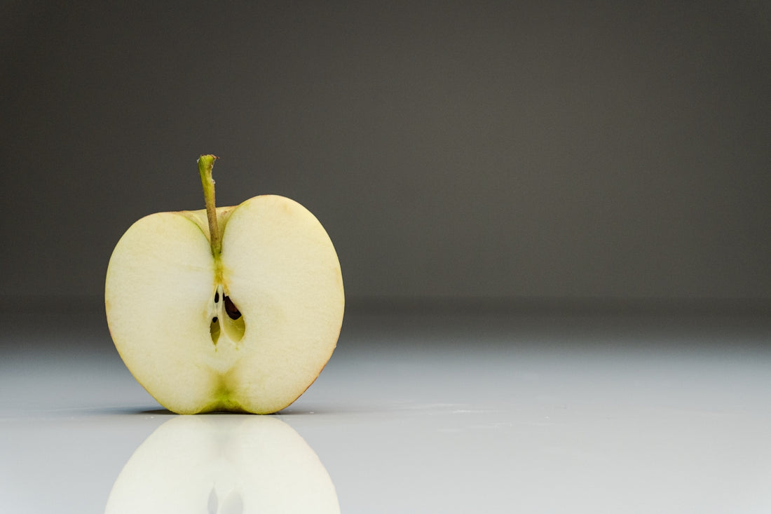 a half eaten apple sitting on top of a table