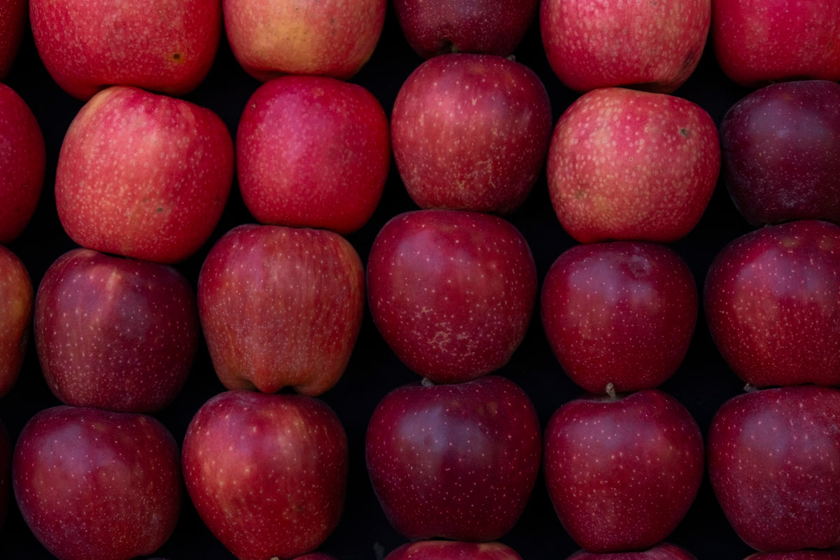 Rows of fresh red apples stacked neatly