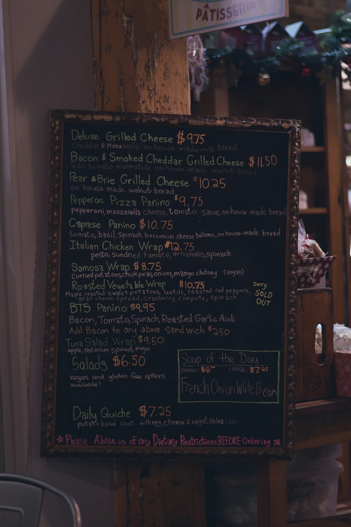 Chalkboard menu with various food items and prices.